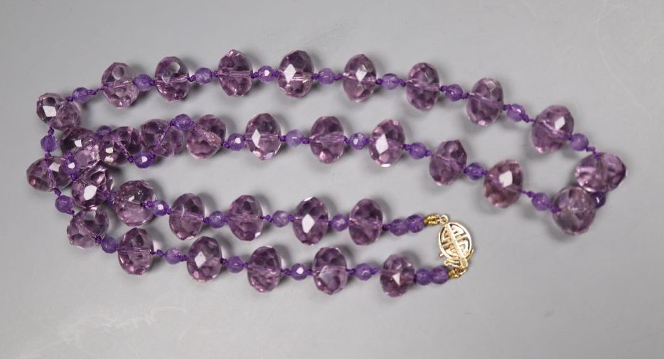 A single strand facetted purple paste bead necklace with 14k yellow metal clasp, 53cm.